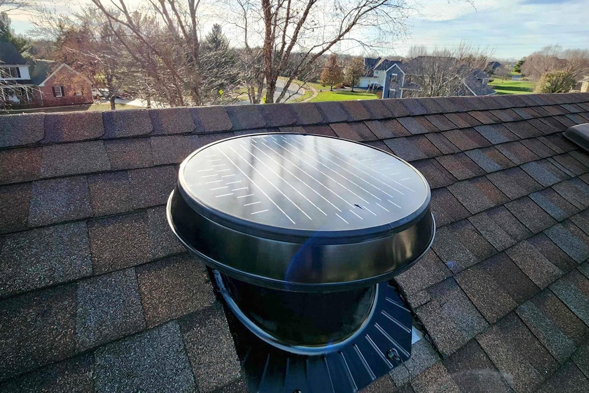 Photograph of a solar attic fan installed on a roof